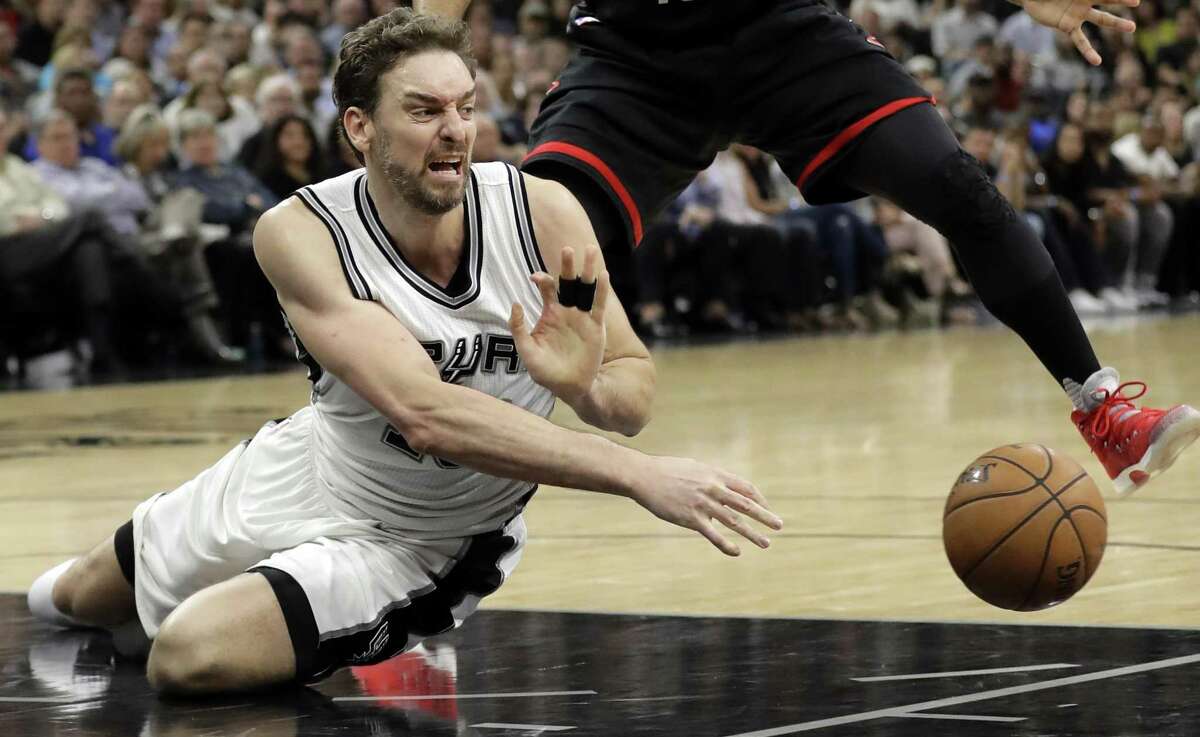 Spurs’ Pau Gasol of Spain passes after collecting a loose ball as Houston Rockets’ Eric Gordon (10) defends during the second half of Game 2 on May 3, 2017, in San Antonio.