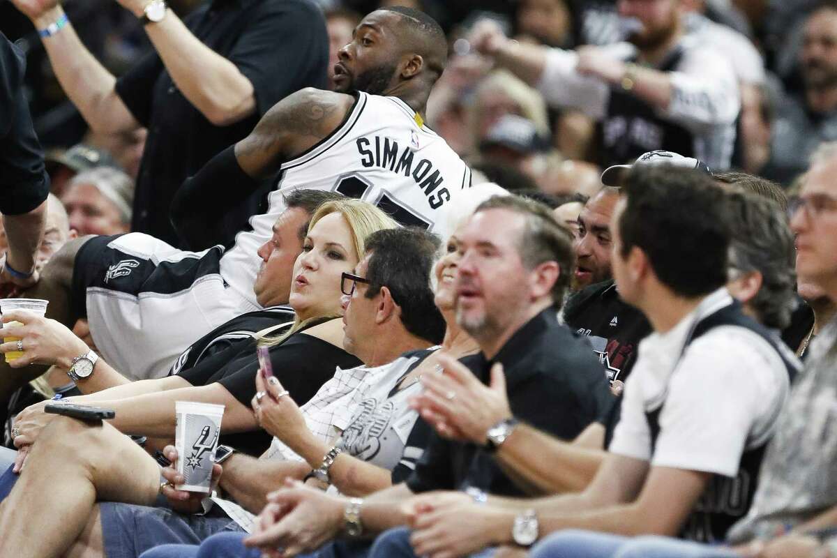 Spurs guard Jonathon Simmons goes into the stands chasing a loose ball during the second half of Game 2 against Houston at the AT&T Center on May 3, 2017, in San Antonio.