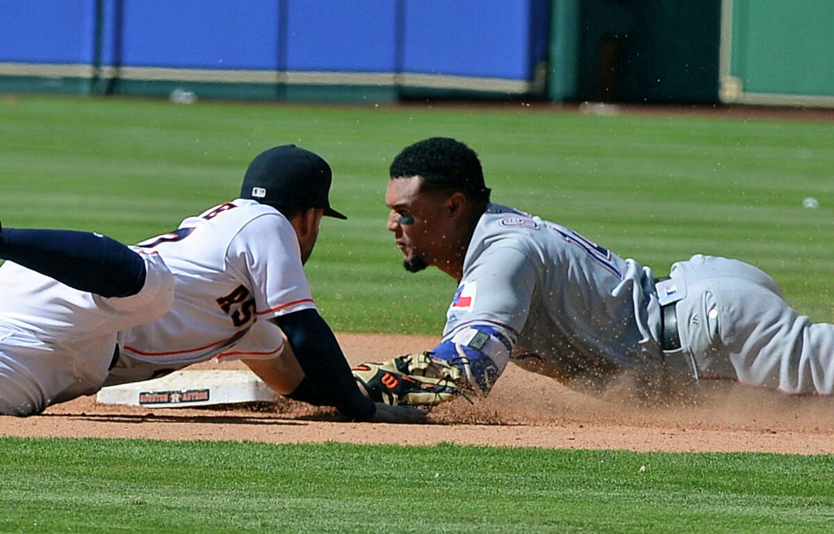 Texas Rangers' Carlos Gomez, right, slides safely in for a double ahead of the tag by Houston Astros second baseman Jose Altuve in the eighth inning of a baseball game Thursday, May 4, 2017, in Houston. (AP Photo/George Bridges)