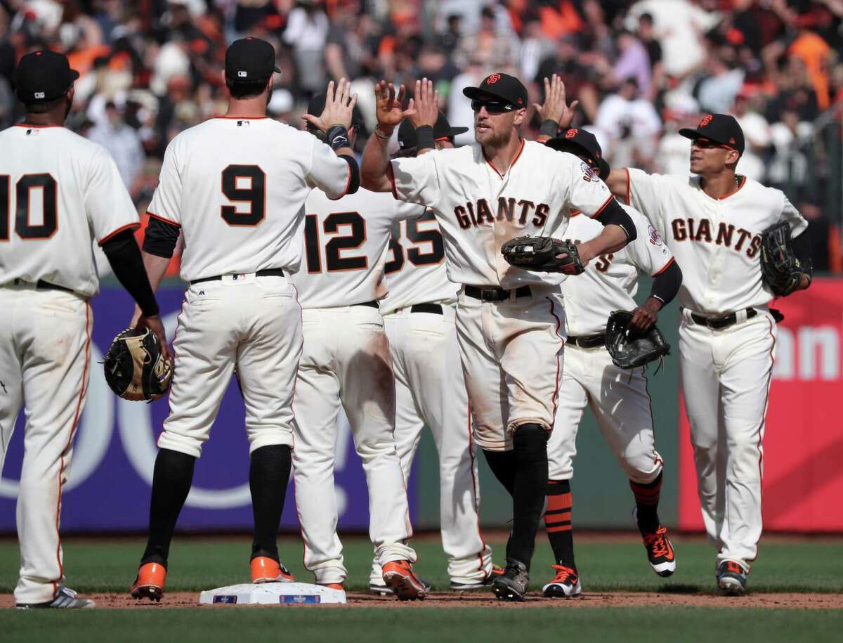 Hunter Pence, (center) joins the team in celebration as the San Francisco Giants beat the Arizona Diamondbacks 4-1 in their home opener at AT&T Park in San Francisco, Calif. on Mon. April 10, 2017.