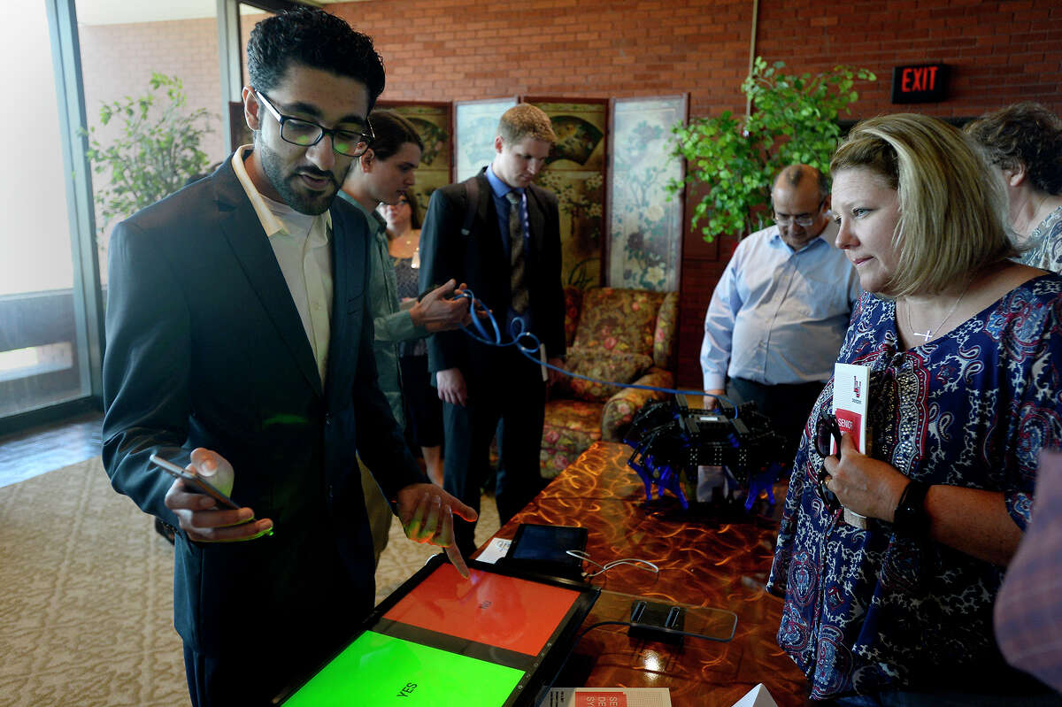 Hassan Al Zaki shows his team's electronic communication system at the Lamar University engineering department's senior design symposium on Thursday. The device helps people with speech disabilities communicate. Photo taken Thursday 5/4/17 Ryan Pelham/The Enterprise