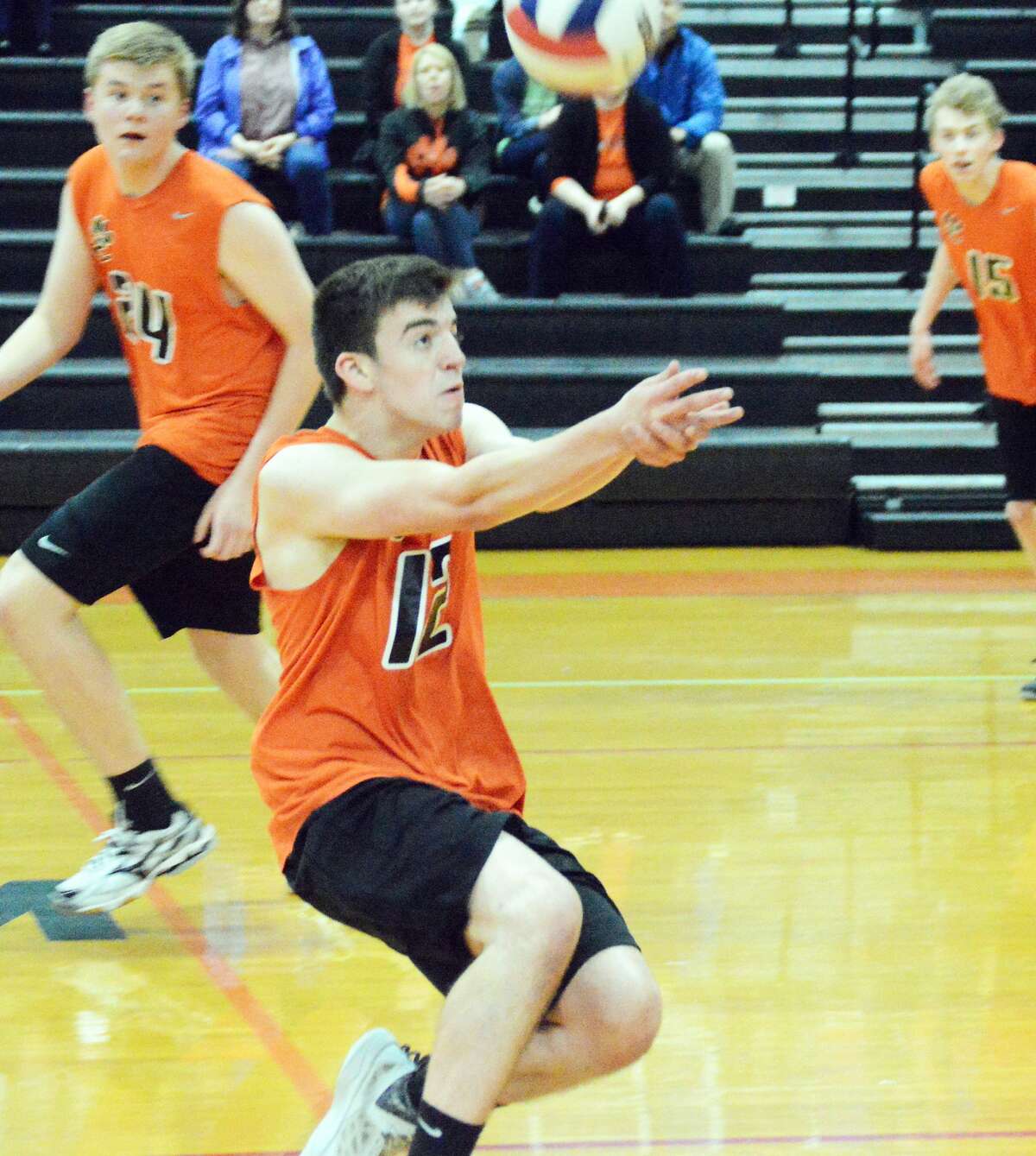 Edwardsville setter Ben Lombardi saves a ball during first-game action against the Granite City Warriors at Lincoln Middle School