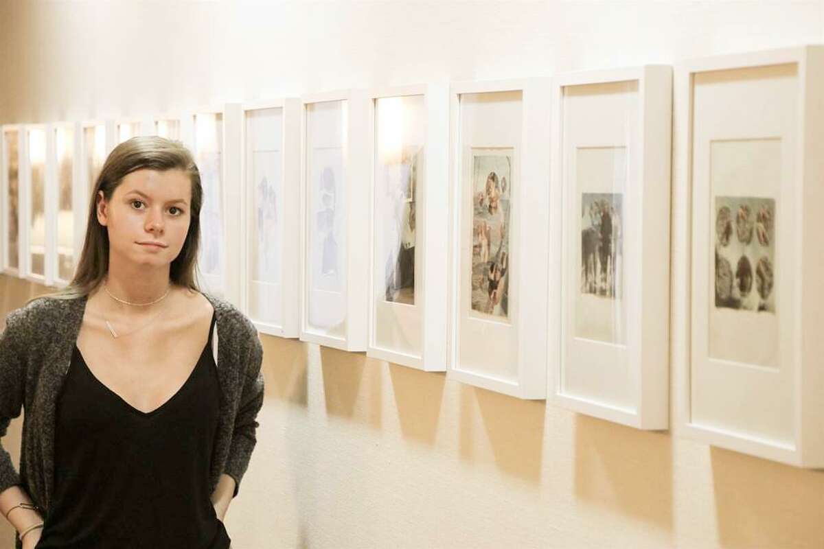 Eden Lucien Neleman, a New Canaan High School junior, stands in front of her “Spliced and Divided” collage exhibit, on display at The Inn, Waveny LifeCare Networks independent living community.
