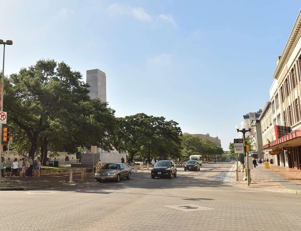 Alamo Street is now open to cars. The Cenotaph Monument is visible behind the large tree at left.