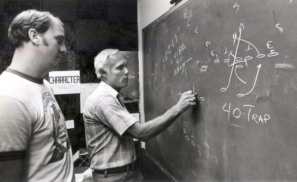 Judson coach Frank Arnold (right) goes over plays with defensive coordinator D.W. Rutledge in 1983.