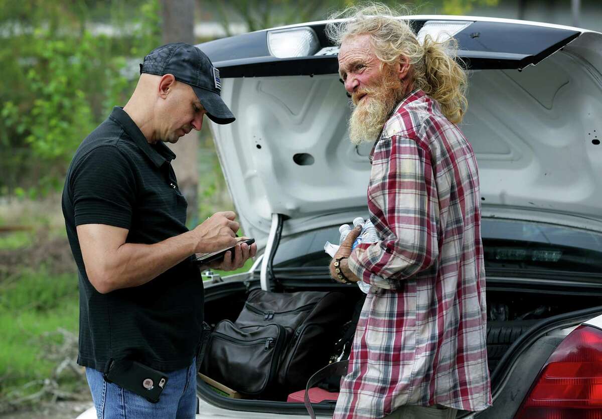 In this 2017 photo, a San Antonio police officer helps a homeless man. As we re-think how we respond to mental health crises, police will stay play a role, and often partner with mental health professionals.