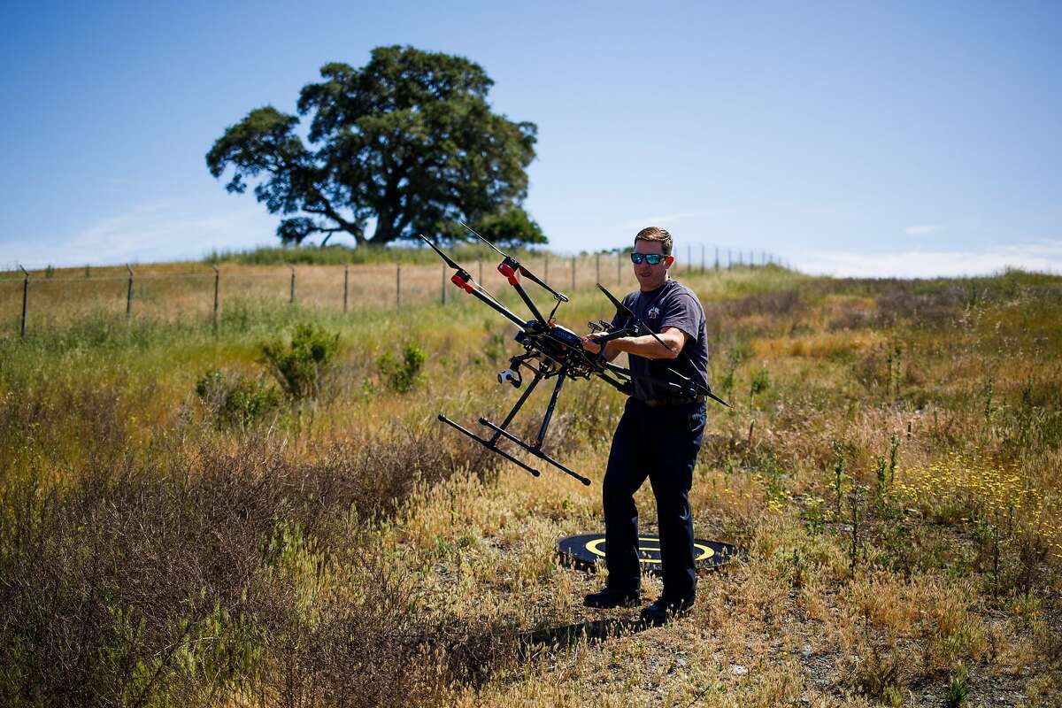Kevin White of the Menlo Park Fire Protection District retrieves the drone during a search and rescue training at SLAC National Accelerator Laboratory in Menlo Park, Calif. Friday, May 5, 2017.