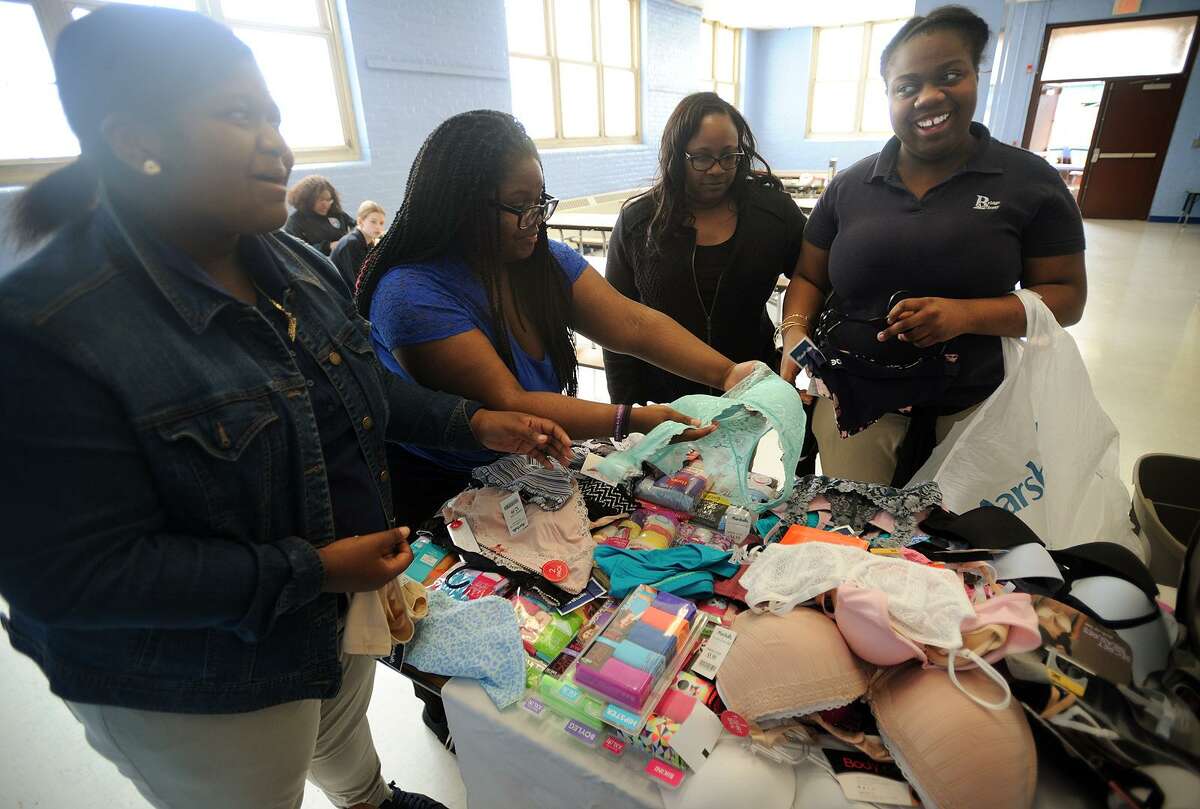 From left; Bridge Academy students Leeasya Lindsey, 15, Nia Diaz, 14, and Asia Stewart, 13, right, sort through bras and underwear purchased for The Undies Project, a Greenwich based charity, at the school in Bridgeport, Conn. on Thursday, May 4, 2017. The girls participate in an afterschool program called Heal, which is focussed on service projects in the community.