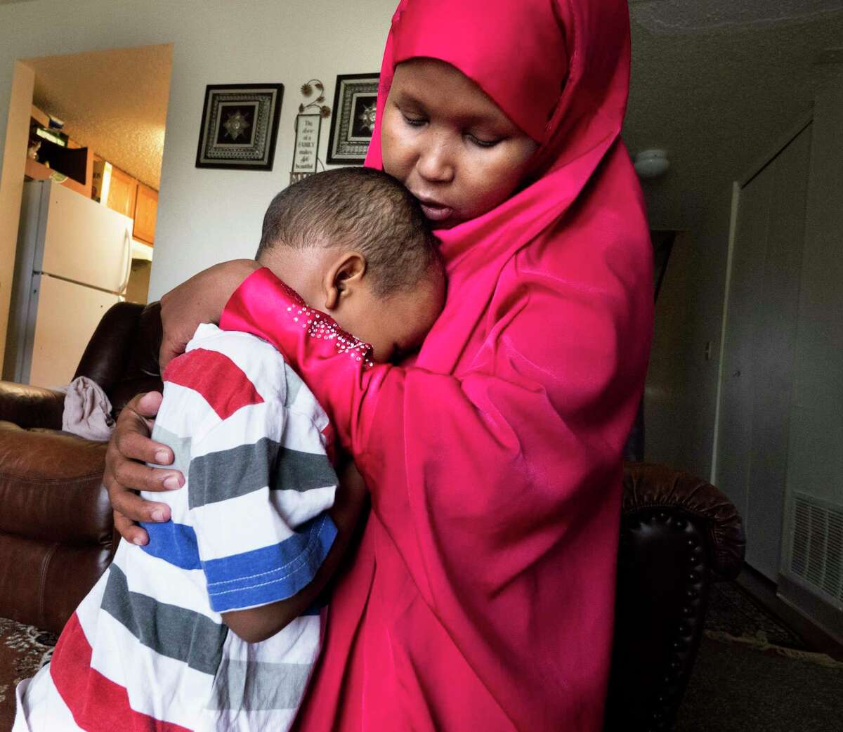 Suaado Salah comforts her 3-year-old son at their apartment in suburban Minneapolis. Luqman and his 18-month-old sister got measles during Minnesota's current outbreak.