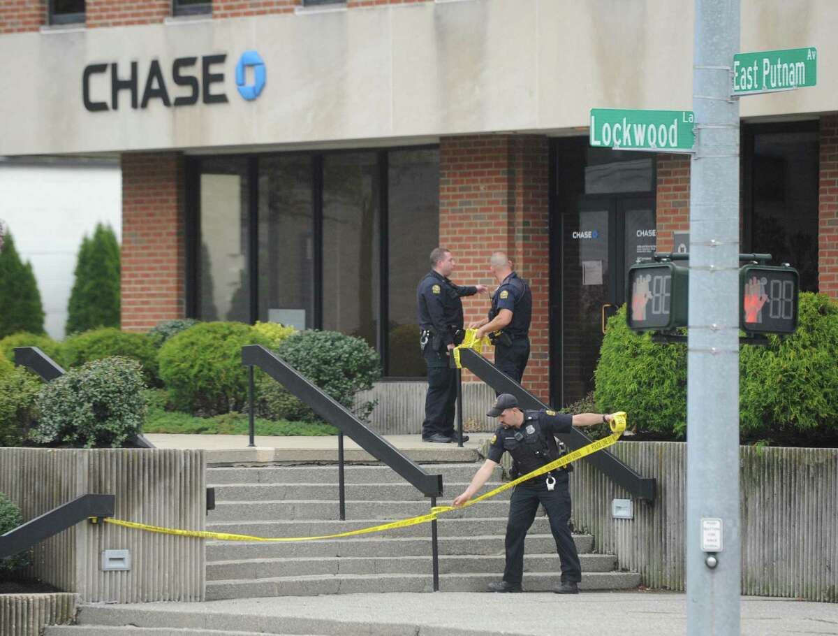 Police respond to a robbery at the Chase Bank in the Riverside section of Greenwich, Conn. Wednesday, April 26, 2017. The same bank was also robbed Tuesday morning with the suspect from that robbery still on the loose.