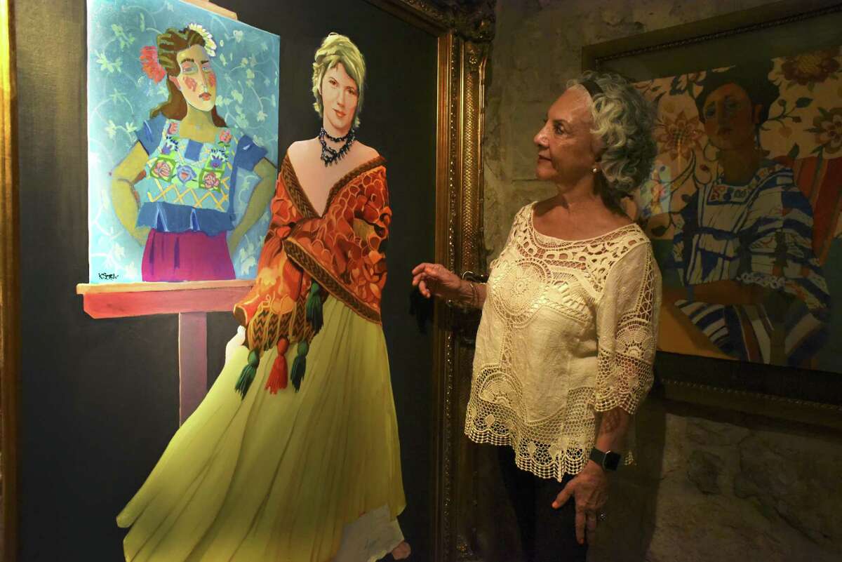 Velma Villegas, retired superintendent of the Southwest Independent School District, admires a painting of Kathy Sosa done by Lionel Sosa on Thursday, May, 4, 2017. The Sosas opened their gallery as part of the Big Give event. They offered to donate half of all proceeds from paintings sold during the event to KIPP Academy, a charter school in San Antonio. The Big Give is a 24-hour day of giving to local charities and nonprofits.