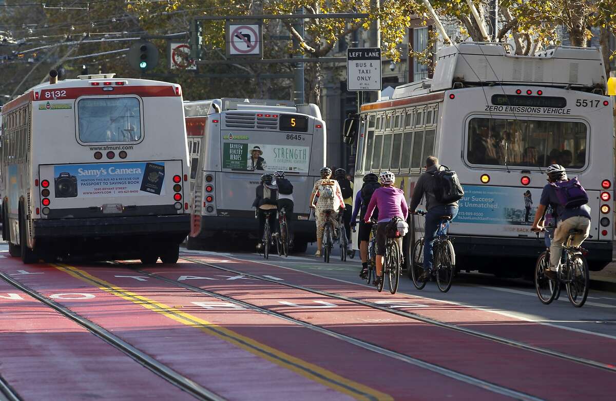 Buses and bicycles vie for space on Market Street near Fifth Street in San Francisco, Calif. on Wednesday, Oct. 21, 2015.