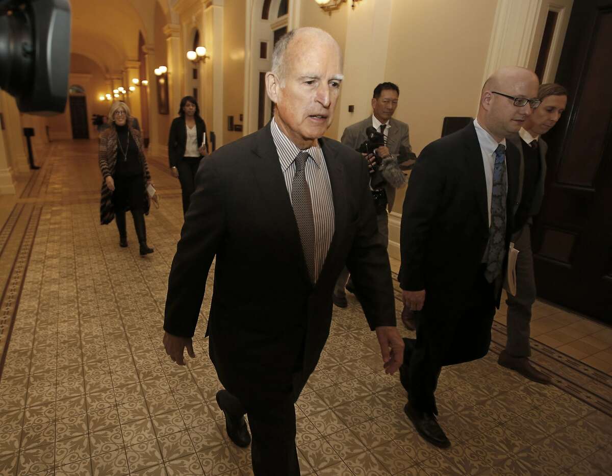 FILE - In this April 6, 2017, file photo, California Gov. Jerry Brown returns to his office after a meeting in Sacramento, Calif. Brown and the California Legislature are among this year’s winners of the Jefferson Muzzles, satiric awards bestowed by a free speech group for what it considers egregious offenses. Brown and legislators passed a law banning online employment databases from listing the ages of actors and actresses. The Charlottesville, Va.-based Thomas Jefferson Center for the Protection of Free Expression announced its awards Thursday, April 27, 2017. (AP Photo/Rich Pedroncelli, File)