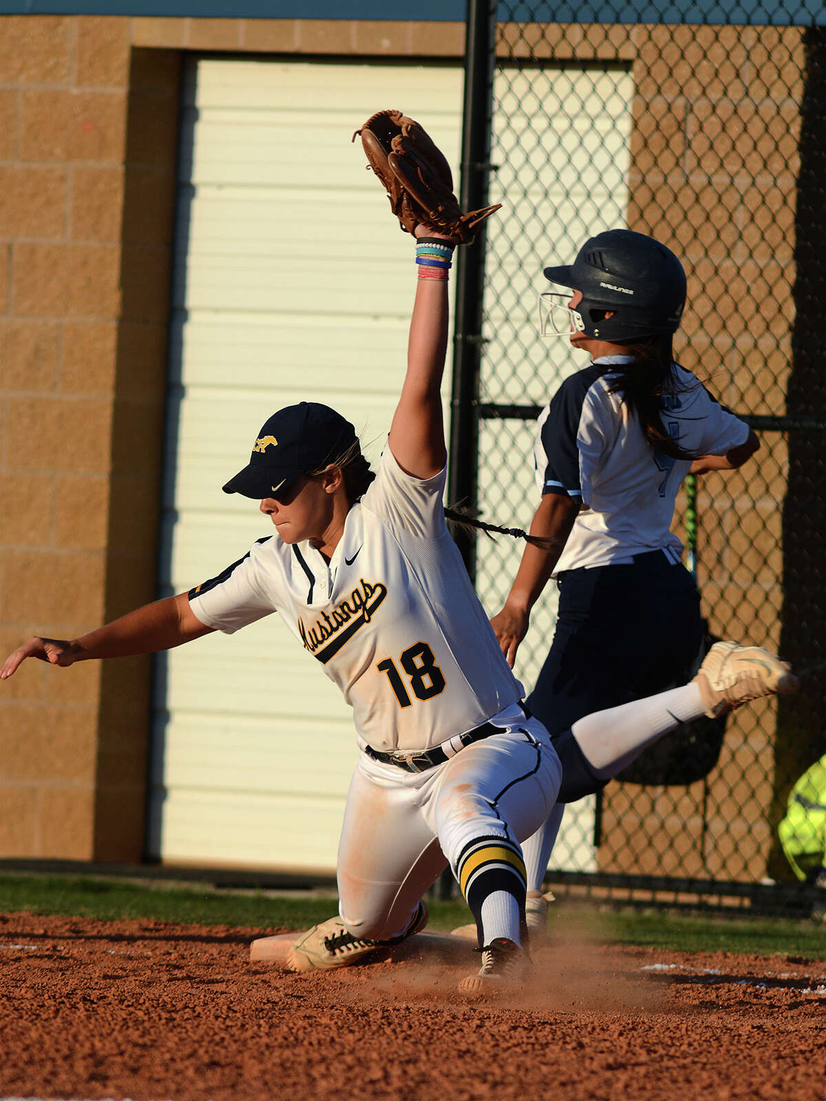 Cy Ranch junior first baseman Bryce West (18) stretches to finish a defensive play against Clements baserunner Tori Garza in the top of the 2nd inning of their Region III-6A Girls Area Round Softball Playoff matchup at Katy Taylor High School on Friday, May 5, 2017. (Photo by Jerry Baker/Freelance