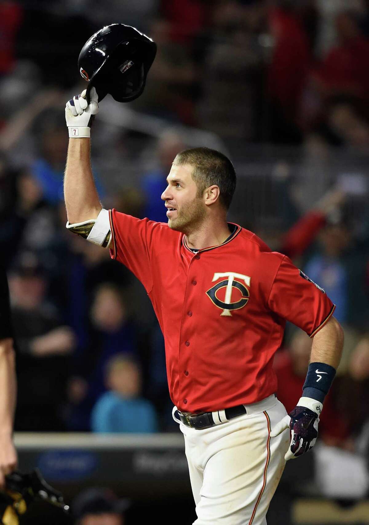 Former Minnesota Twins player Joe Mauer waves to fans after being