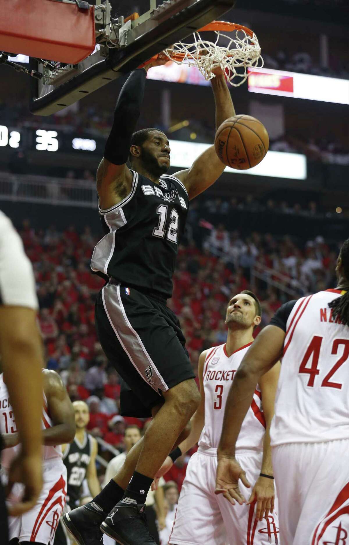 The Spurs’ LaMarcus Aldridge (12) dunks against the Rockets at the Toyota Center on Friday. Aldridge tied Kawhi Leonard with a team-high 26 points.