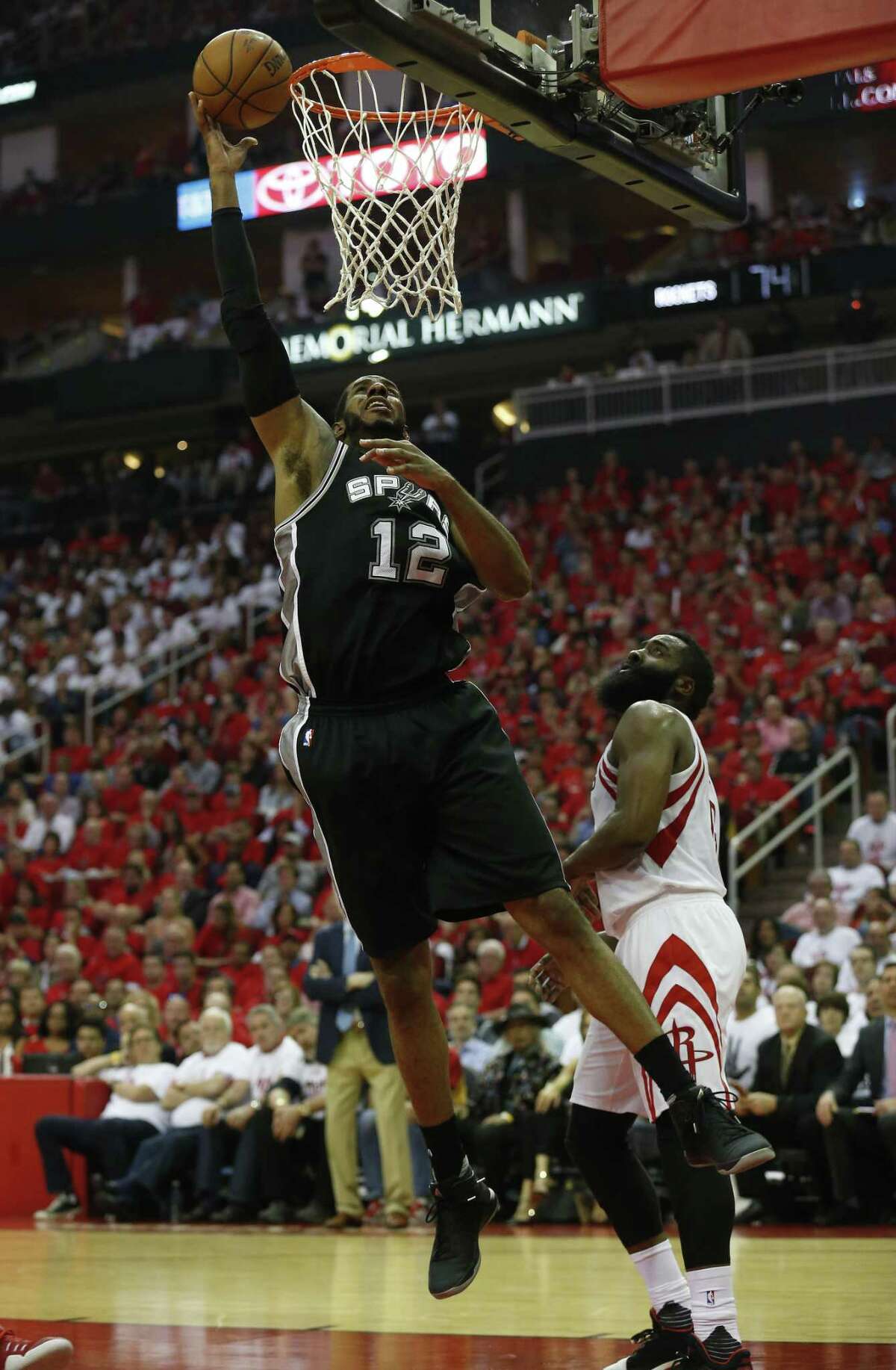 Spurs' LaMarcus Aldridge (12) scores against Houston Rockets' James Harden (13) in Game 3 at the Toyota Center on Friday, May 5, 2017. (Kin Man Hui/San Antonio Express-News)
