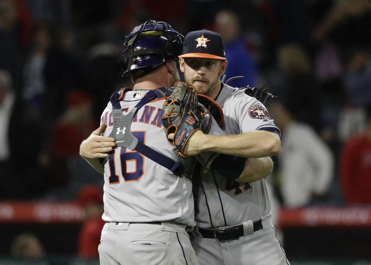 Houston Astros relief pitcher Brad Peacock, right, hugs catcher Brian McCann after their team defeated the Los Angeles Angels 7-6 in the 10 innings in a baseball game, Friday, May 5, 2017, in Anaheim, Calif. (AP Photo/Jae C. Hong)