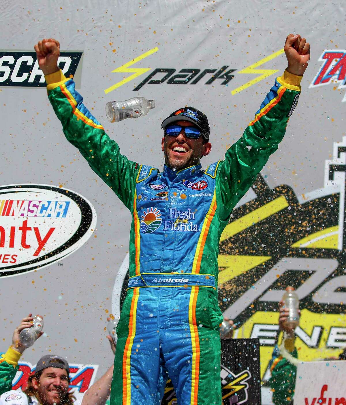 Aric Almirola celebrates in Victory Lane after winning the NASCAR Xfinity series auto race at Talladega Superspeedway, Saturday, May 6, 2017, in Talladega, Ala. (AP Photo/Butch Dill)