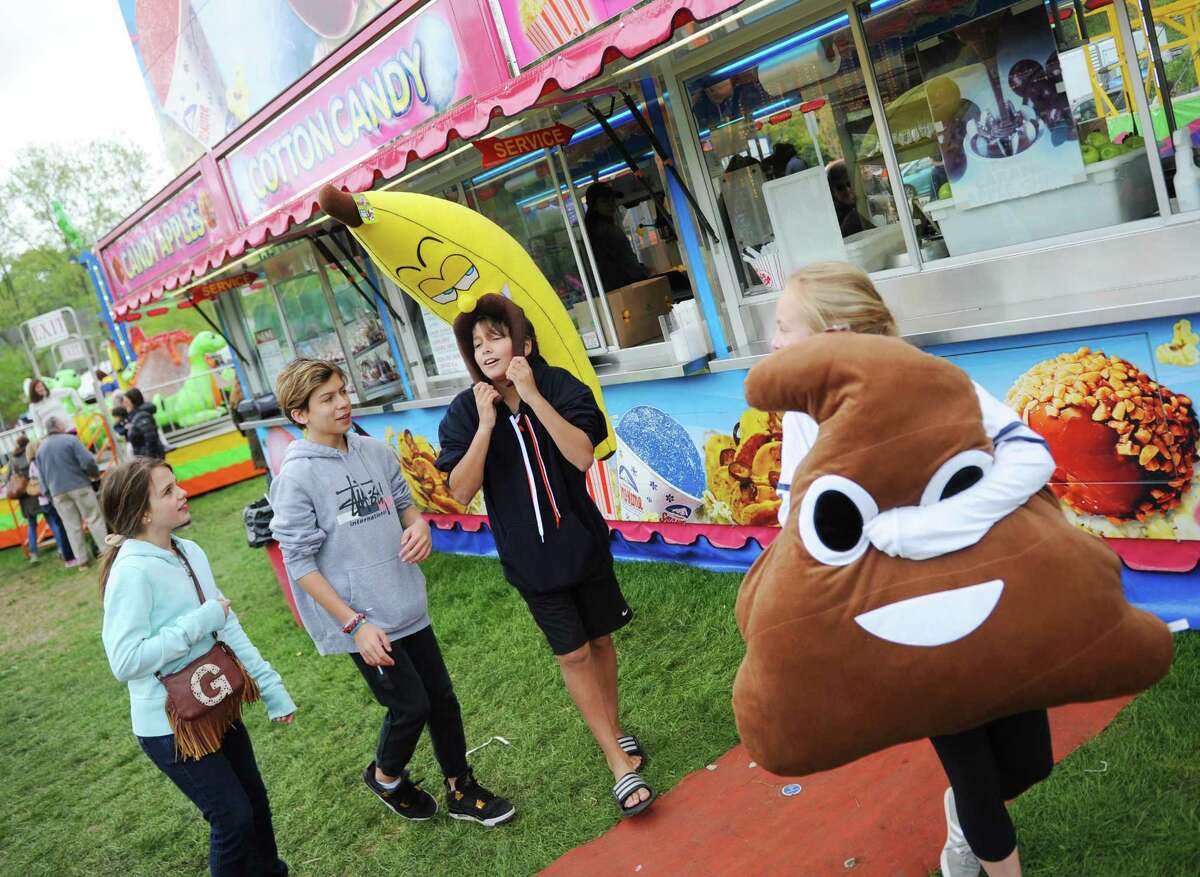 Greenwich's Grace Feldman, left, 10, and Max Feldman, 12, talk to their friends Dylan Cooper, 12, and Alexandra Cavin, 12, after they won a stuffed banana and poop emoji at the North Mianus Pow Wow Carnival at North Mainus School in the Riverside section of Greenwich, Conn. Sunday, May 7, 2017. The carnival, held on Saturday and Sunday, was complete with rides, games, food, musical entertainment and a raffle, making it the largest PTA fundraiser of the year for the school.