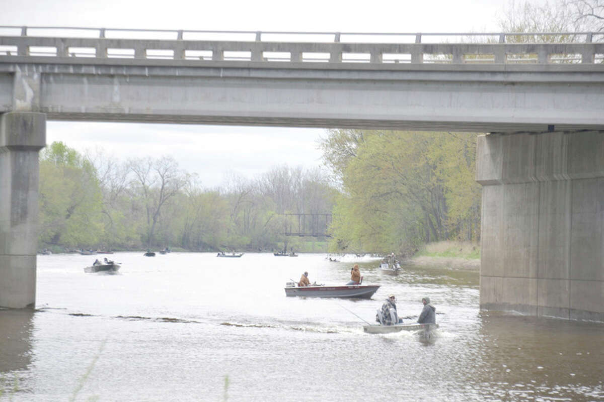 STEVE GRIFFIN | for the Daily News The Gordonville Road bridge frames a boat-filled Tittabawassee River last Saturday, the opening day of the walleye fishing season.