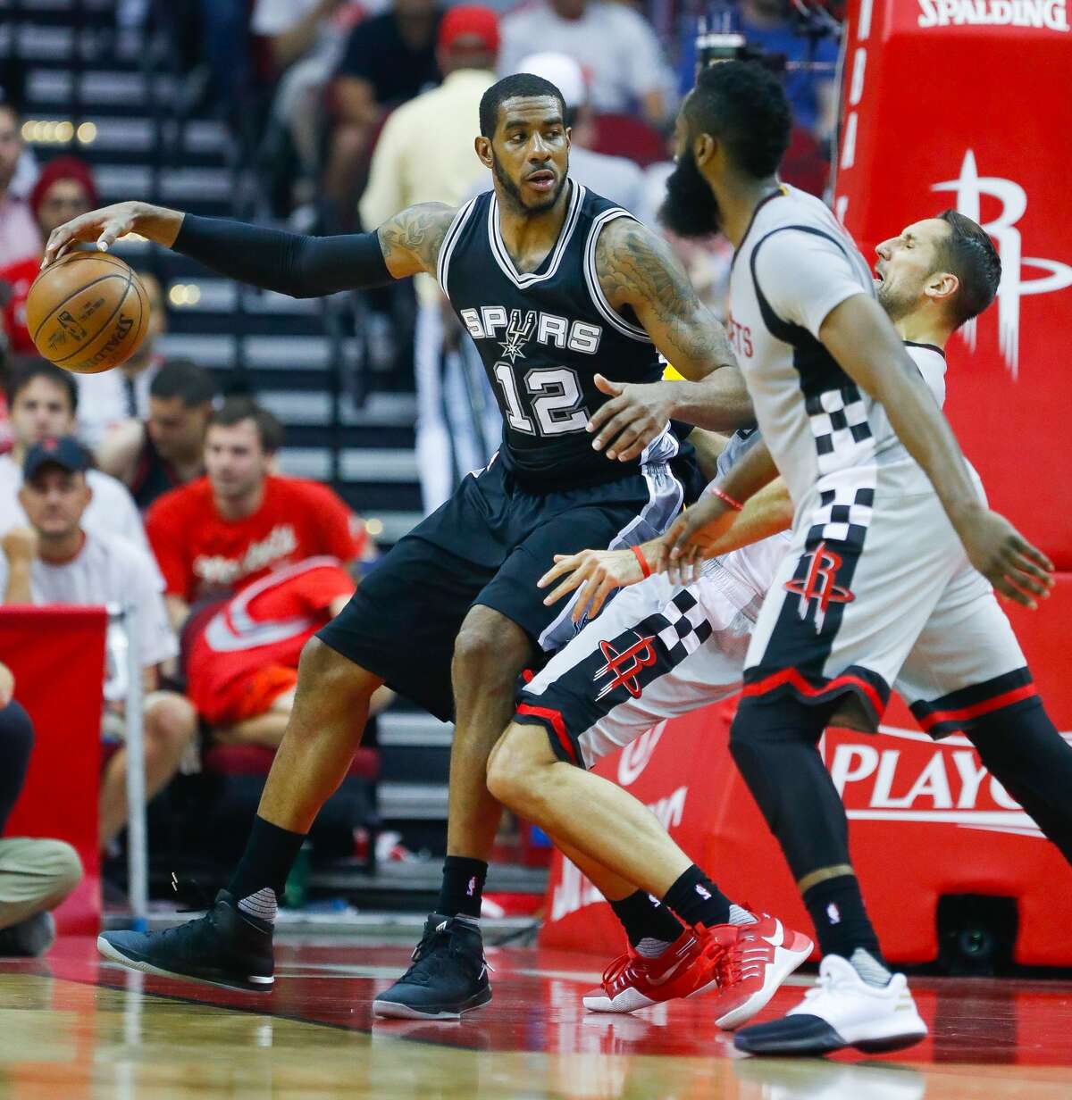San Antonio Spurs forward LaMarcus Aldridge (12) backs into Houston Rockets forward Ryan Anderson (3) during the first half of Game 3 of the second round of the Western Conference NBA playoffs at the Toyota Center, Sunday, May 7, 2017, in Houston. ( Karen Warren / Houston Chronicle )