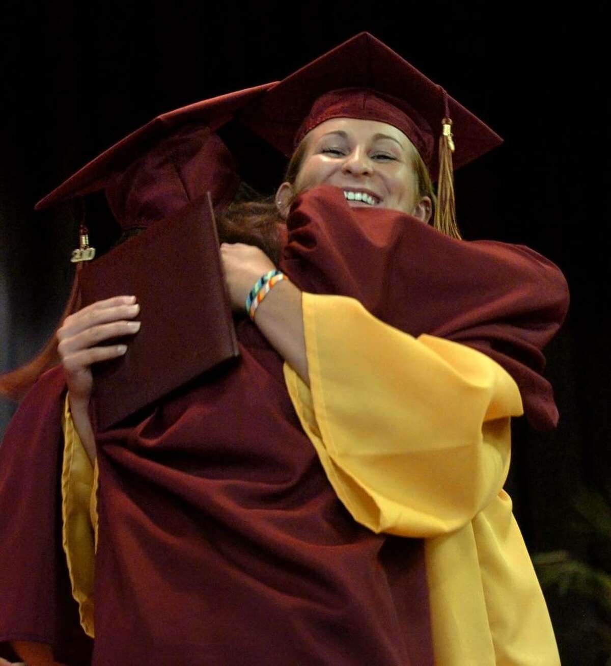 Graduates Monica Hirschbeck, facing camera, and Rachel Heyse hug each other after getting their diplomas, during St. Joseph's Class of 2010 Commencement Exercises in Trumbull, Conn. on Saturday June 05, 2010.