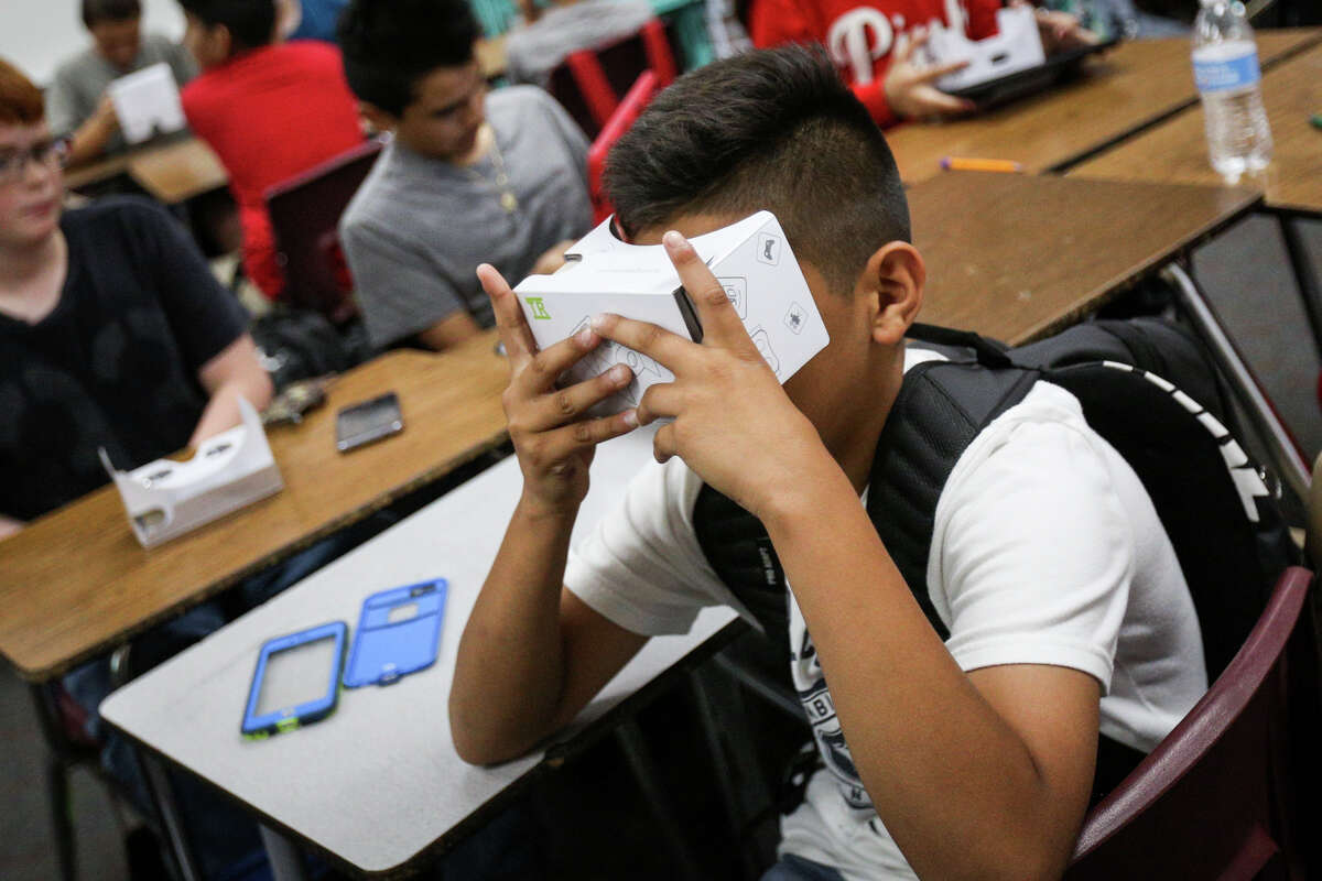 Sixth grader Israel Mentado-Perez looks through a pair of virtual reality viewfinders at the Grand Canyon during class on Friday, April 28, 2017, at Lynn Lucas Middle School.