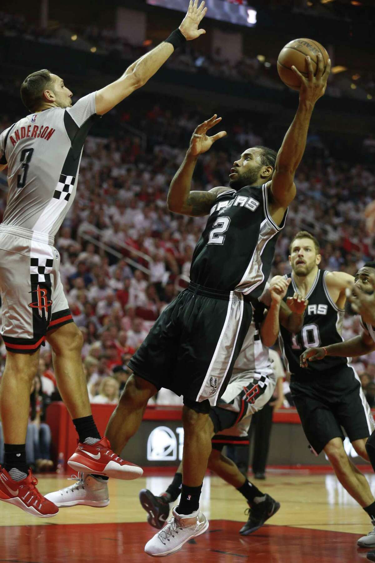 Spurs’ Kawhi Leonard shoots against the Rockets’ Ryan Anderson in Game 4 at the Toyota Center on May 7, 2017.