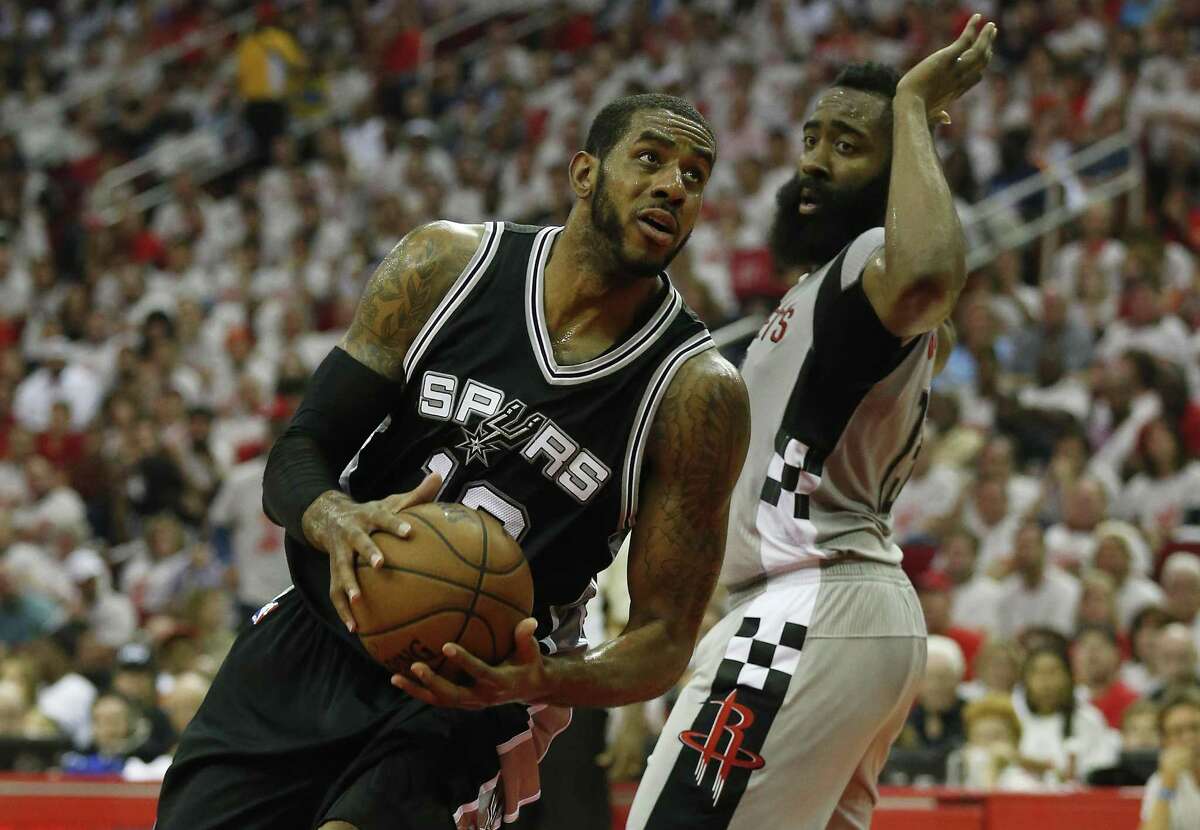 Spurs’ LaMarcus Aldridge looks for a shot in the paint against the Rockets’ James Harden in Game 4 at the Toyota Center on May 7, 2017.