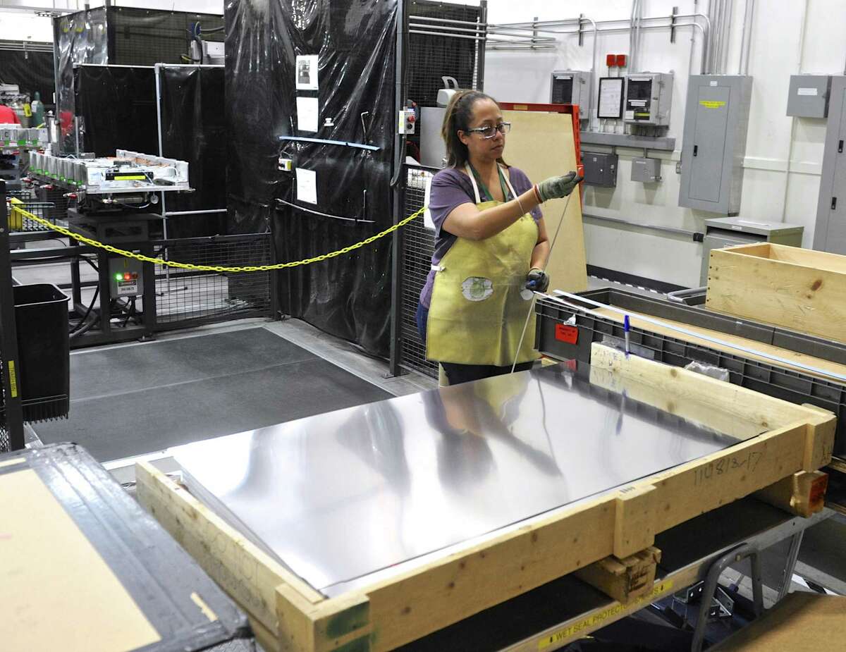 Raquel Johnson readies pieces for a component to be welded at FuelCell Energy manufacturing plant in Torrington, Conn. Wednesday, February 1, 2017.