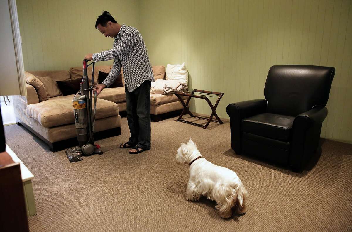 Airbnb host Peter Kwan co-chairman of the Homesharers Democratic Club, with his dog, "Haley" close by prepares his rental for the next guest at his home in North Beach neighborhood in San Francisco, Ca., on Monday May 8, 2017. Kwan has been registered with the city ever since it became possible.