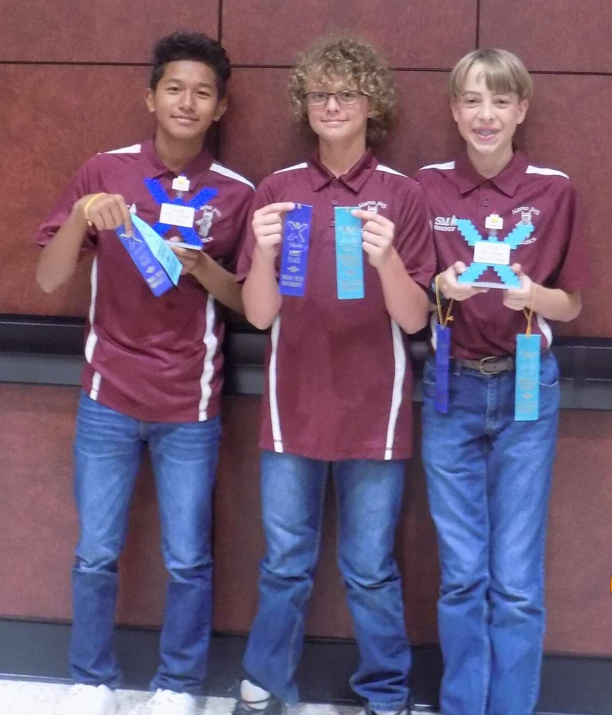 Eight robotics teams from Alamo Junior High School competed at the GEAR contest championship April 29 in Lubbock. The Ballers won first place and the Pinnacle Award. Members are Joshua Lian, from left, Maison Greer and Ryan Parmer.