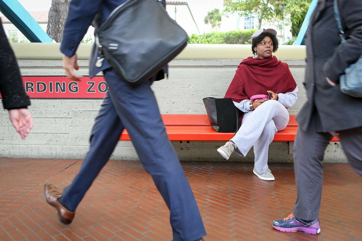 Math teacher and badminton coach Etoria Cheeks waits for the train after leaving The Academy high school to return to her temporary living situation on Tuesday, April 4, 2017 in San Francisco, Calif. It is not unusual for Cheeks to spend 12 hour days at the school.