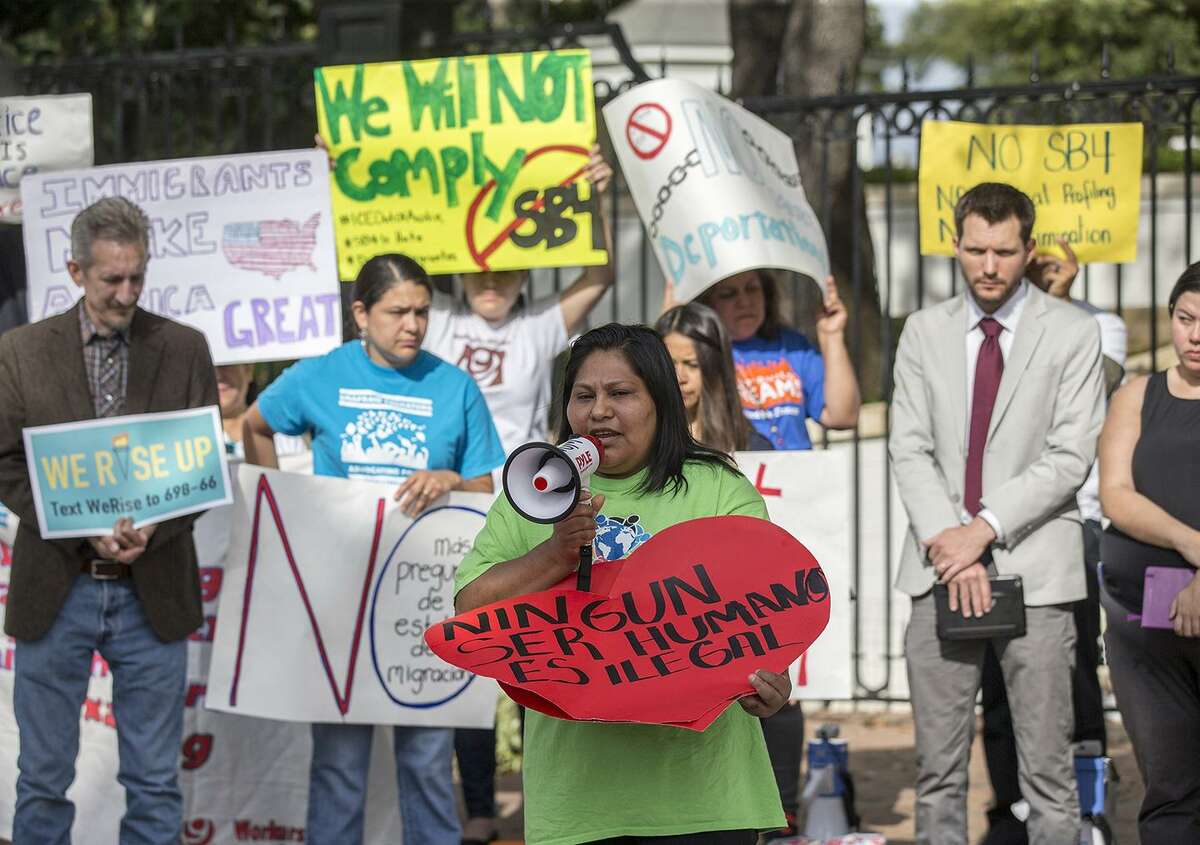 Maria Duque speaks during a protest outside of the Texas Governor's Mansion in Austin, Texas, Monday, May 8, 2017. The gathering was to protest a law, which takes effect in September and which critics say is the most anti-immigrant since a 2010 Arizona law, that will allow police officers to ask about the immigration status of anyone they detain, including during routine traffic stops. Republican Gov. Greg Abbott signed the law Sunday evening on Facebook Live with no advanced warning. (Ricardo B. Brazziell/Austin American-Statesman via AP)