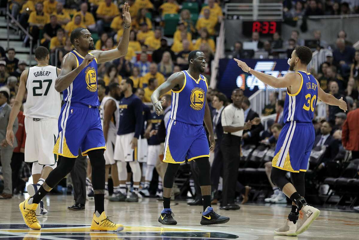 Kevin Durant (35), Draymond Green (23) and Stephen Curry (30) high five during a timeout in the second half as the Golden State Warriors played the Utah Jazz at Vivint Smart Home Arena in Salt Lake City, Utah, on Monday, May 8, 2017, in Game 4 of the 2017 Western Conference Semifinals. The Warriors defeated the Jazz 121-95 to sweep the series and advance to the Western Conference Finals