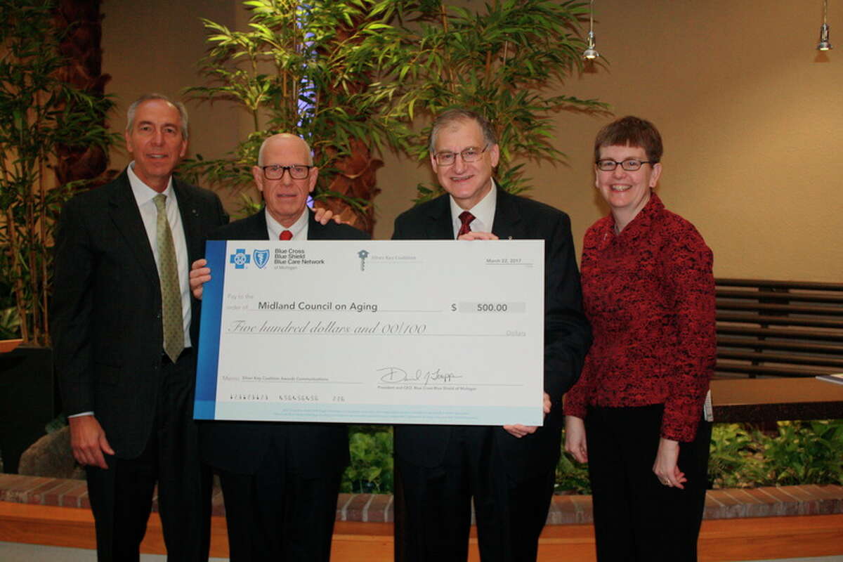 Senior Services Executive Director Alan Brown, third from left, accepts the Tess Canja Innovation Award. Pictured with him, from left, are Jim McGuire, Silver Key Coalition chairman; Sen. Jim Marleau; and Suzanne Miller, of Blue Cross/Blue Shield of Michigan.