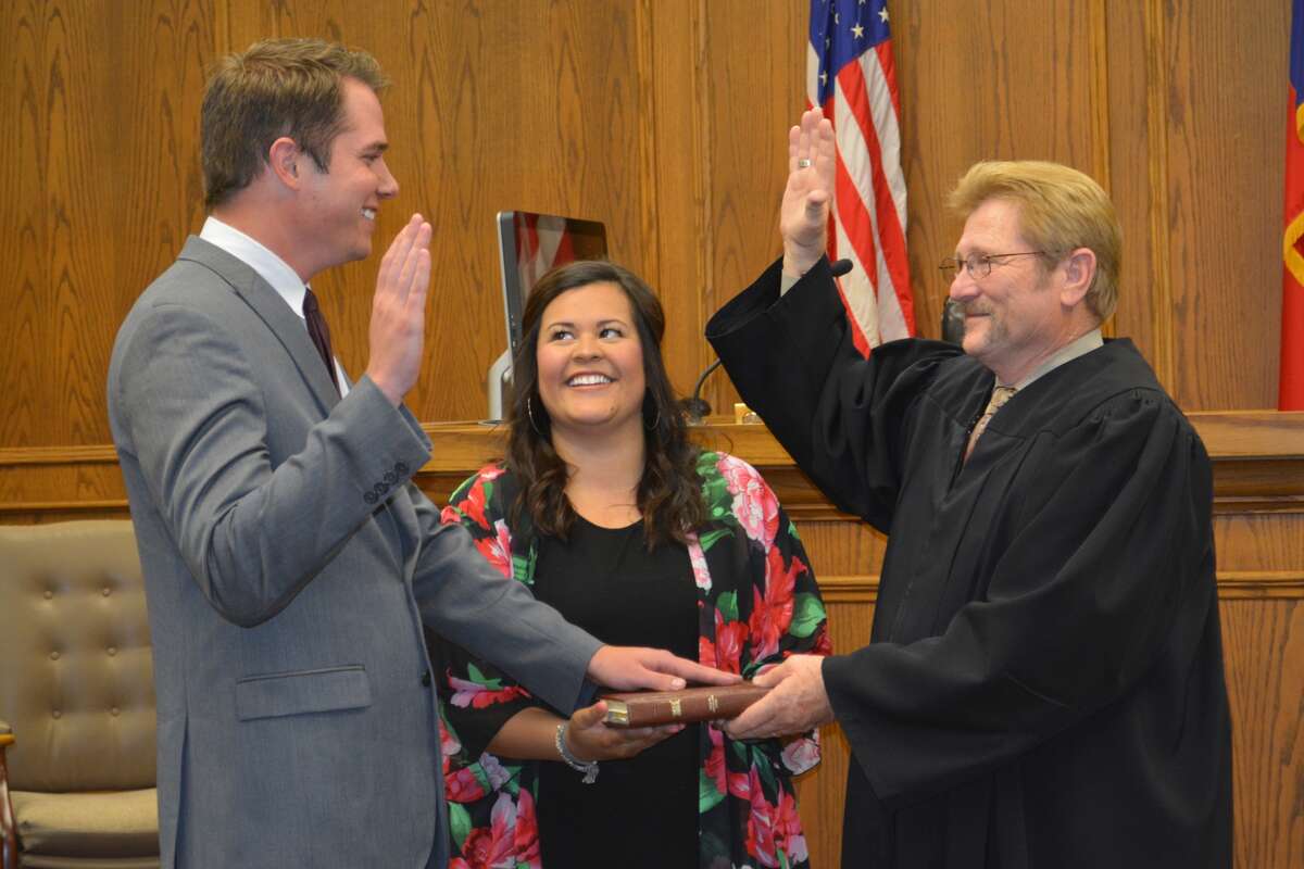 With his wife Lorena holding a Bible, Mitch Williams takes the Texas Lawyer’s Oath from Hale County Judge Bill Coleman on Monday at the courthouse. From Gould, Okla., Williams completed his undergraduate degree at Oklahoma State University and his law degree at Texas Tech University. Williams has been a law clerk at Lafont Formby & Hamilton, L.L.P., while preparing for the bar exam, which he passed on his first attempt. Williams is the son-in-law of Precinct 2 Commissioner Mario Martinez.
