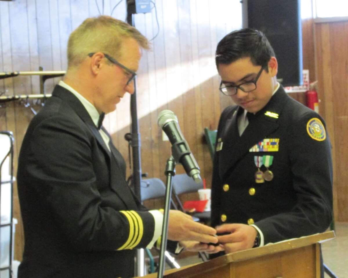 Cadet Lt. Junior Grade Khalil Olalde receives the National Sojourners Award from Lt. Cmdr. David Sandahl, USCG (ret.).
