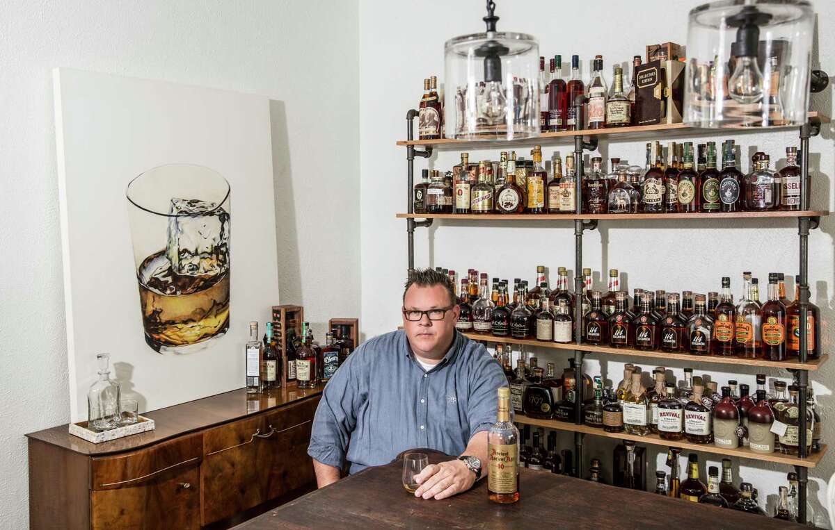 Chris Shepherd at home in Montrose, surrounded by his whiskey collection.