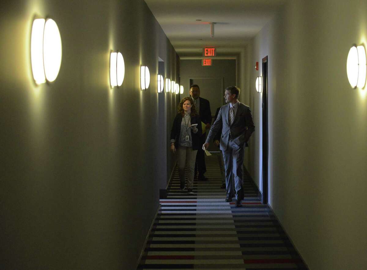 Members of the Stamford Chamber of Commerce and the media walk a hallway during a tour of the new UConn Stamford dorms on May 4, 2017.
