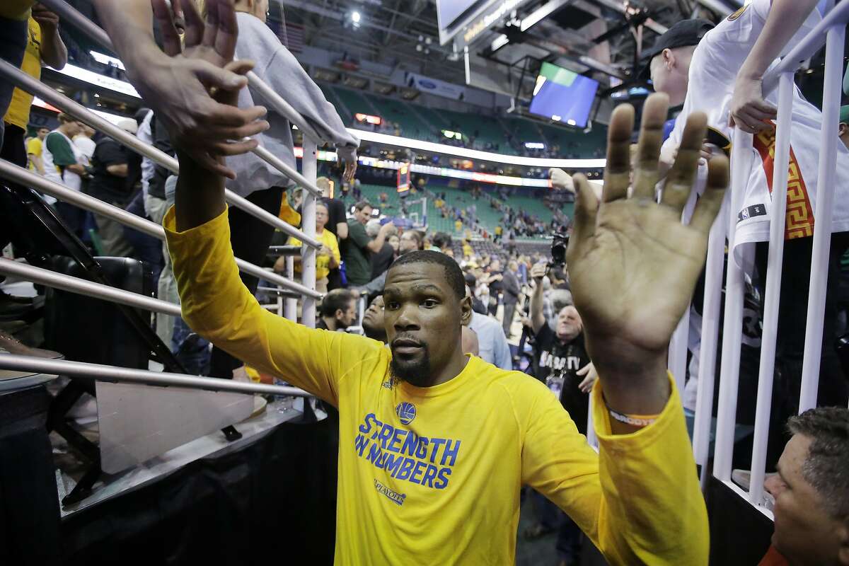 Fans reach for Golden State Warriors forward Kevin Durant (35) as he leaves the court after Game 4 of the NBA basketball second-round playoff series against the Utah Jazz Monday, May 8, 2017, in Salt Lake City. The Warriors won 121-95. (AP Photo/Rick Bowmer)