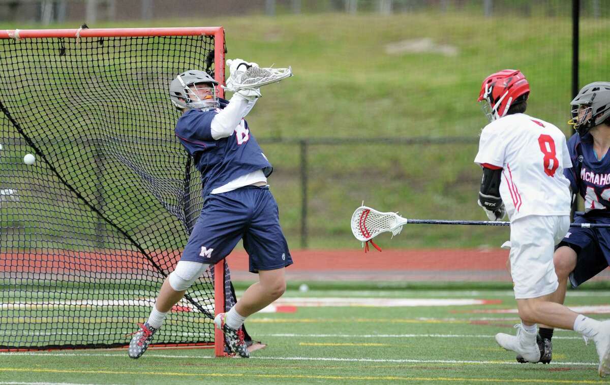 At left, Brien McMahon goalie Peter Ripperger fails to stop a goal by Jackson Peters (8) of Greenwich, at right, during the boys high school lacrosse match between Greenwich High School and Brien McMahon High School at Greenwich, Conn., Tuesday, May 9, 2017.