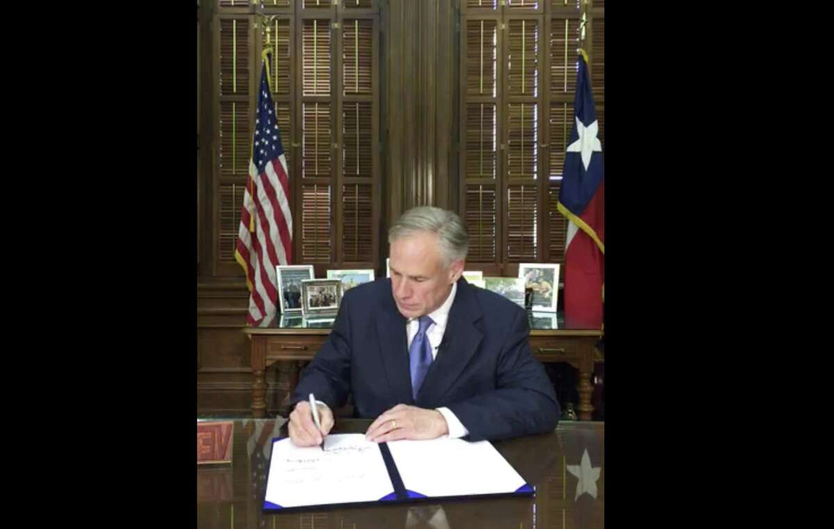 In this May 7 frame from video posted by the Office of the Governor, Gov. Greg Abbott signs a so-called “sanctuary cities” ban in Austin Texas. The ban lets police ask during routine stops whether someone is in the U.S. legally and threatens sheriffs with jail if they don’t cooperate with federal immigration agents.