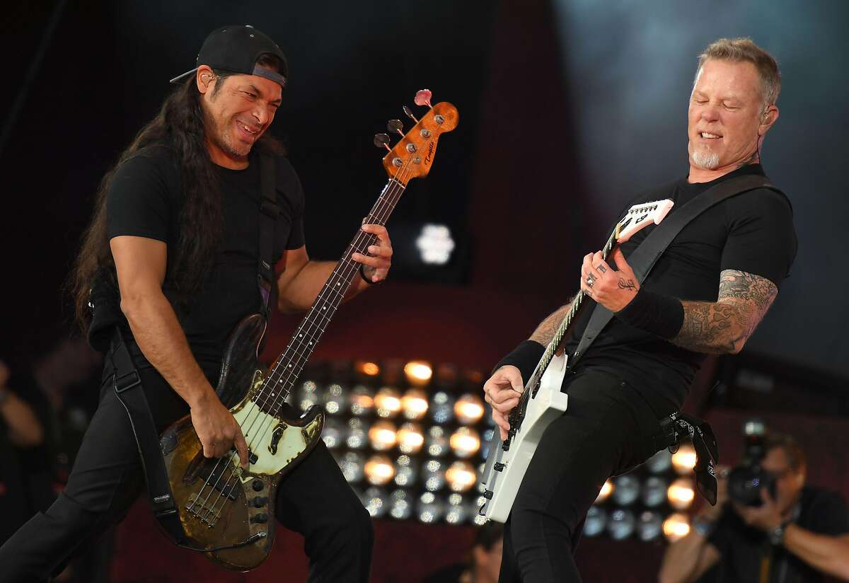 (FILES) This file photo taken on September 24, 2016 shows Robert Trujillo (L) and James Hetfield of Metallica performing at the 2016 Global Citizen Festival in Central Park to end extreme poverty by 2030 at Central Park in New York. Rock music has long centered around youth but metal band Korn is going to a new extreme -- the 12-year-old son of Metallica's bassist is joining them on tour. Korn said that Tye Trujillo, a bassist like his father Robert Trujillo, will play with the band on Latin American dates this month. / AFP PHOTO / ANGELA WEISSANGELA WEISS/AFP/Getty Images
