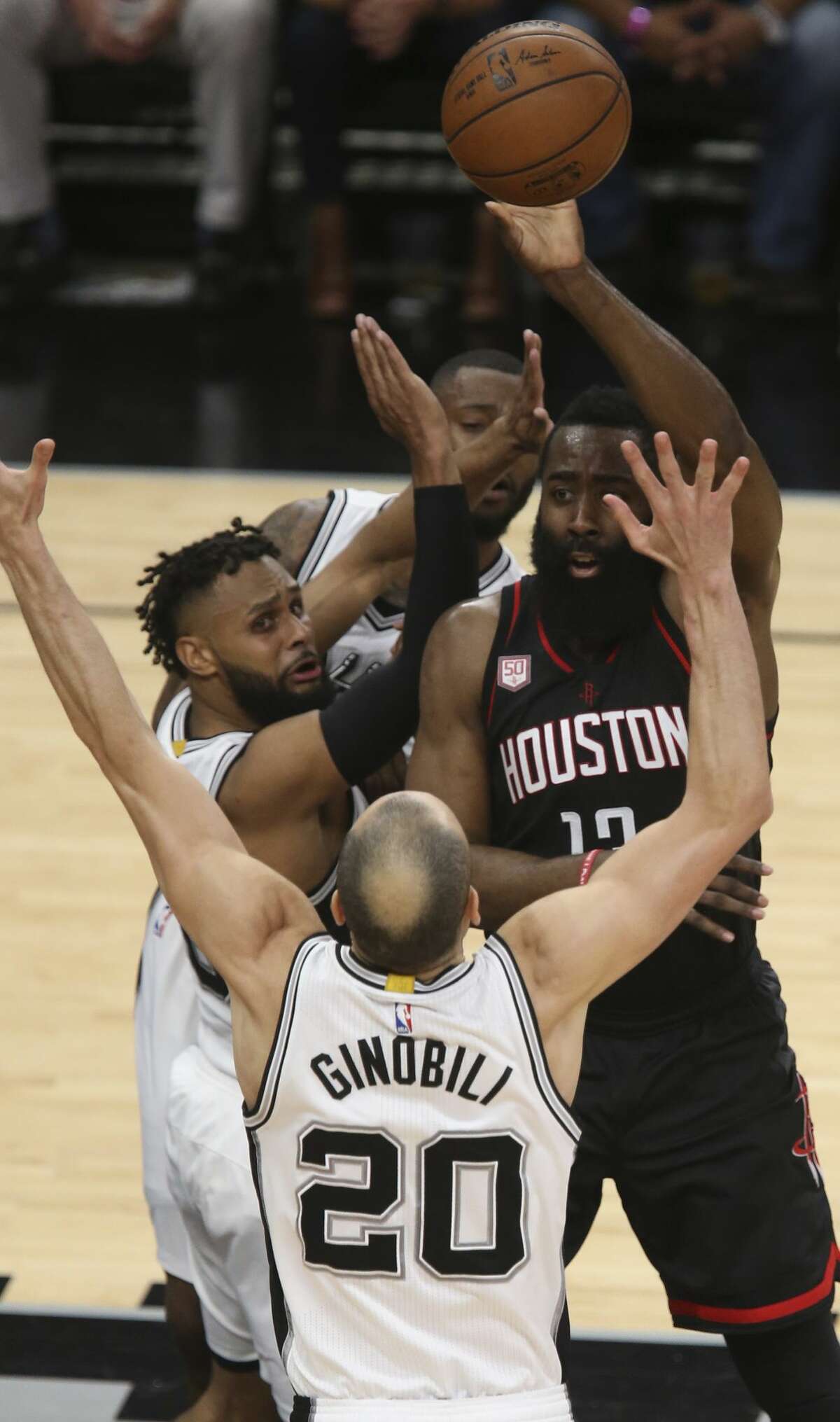 San Antonio Spurs?’ Manu Ginobili, Patty Mills and Jonathon Simmons surround Houston Rockets?’ James Harden during the first half of game five in the Western Conference semifinals at the AT&T Center, Tuesday, May 9, 2017.