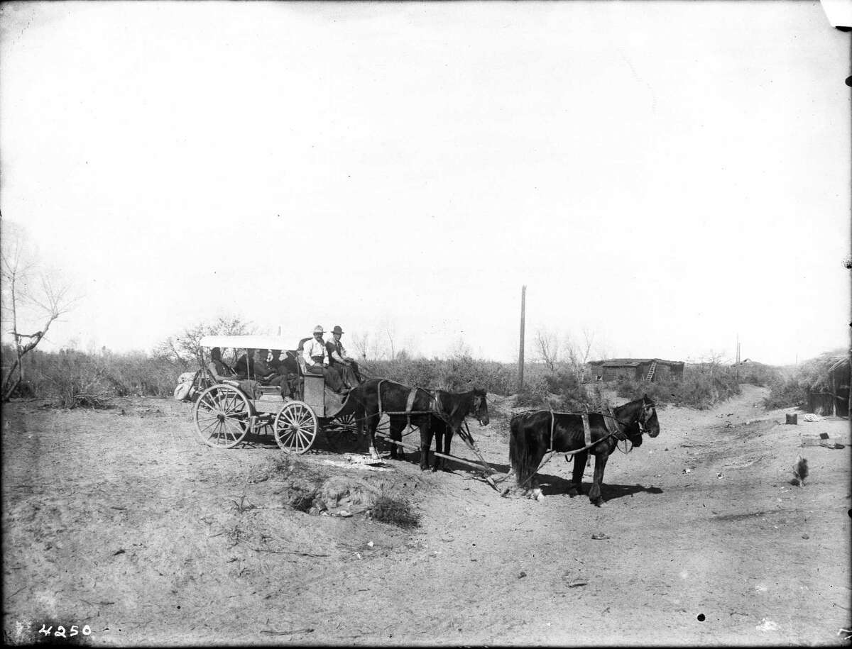 A full stagecoach travels along a dirt road in Yuma, Arizona, circa 1905, well after the San Antonio — San Diego mail route ended. The route was previously used for mail instead of passengers. And in this photo, horses pull the coach rather than the mules normally used on the mail line.