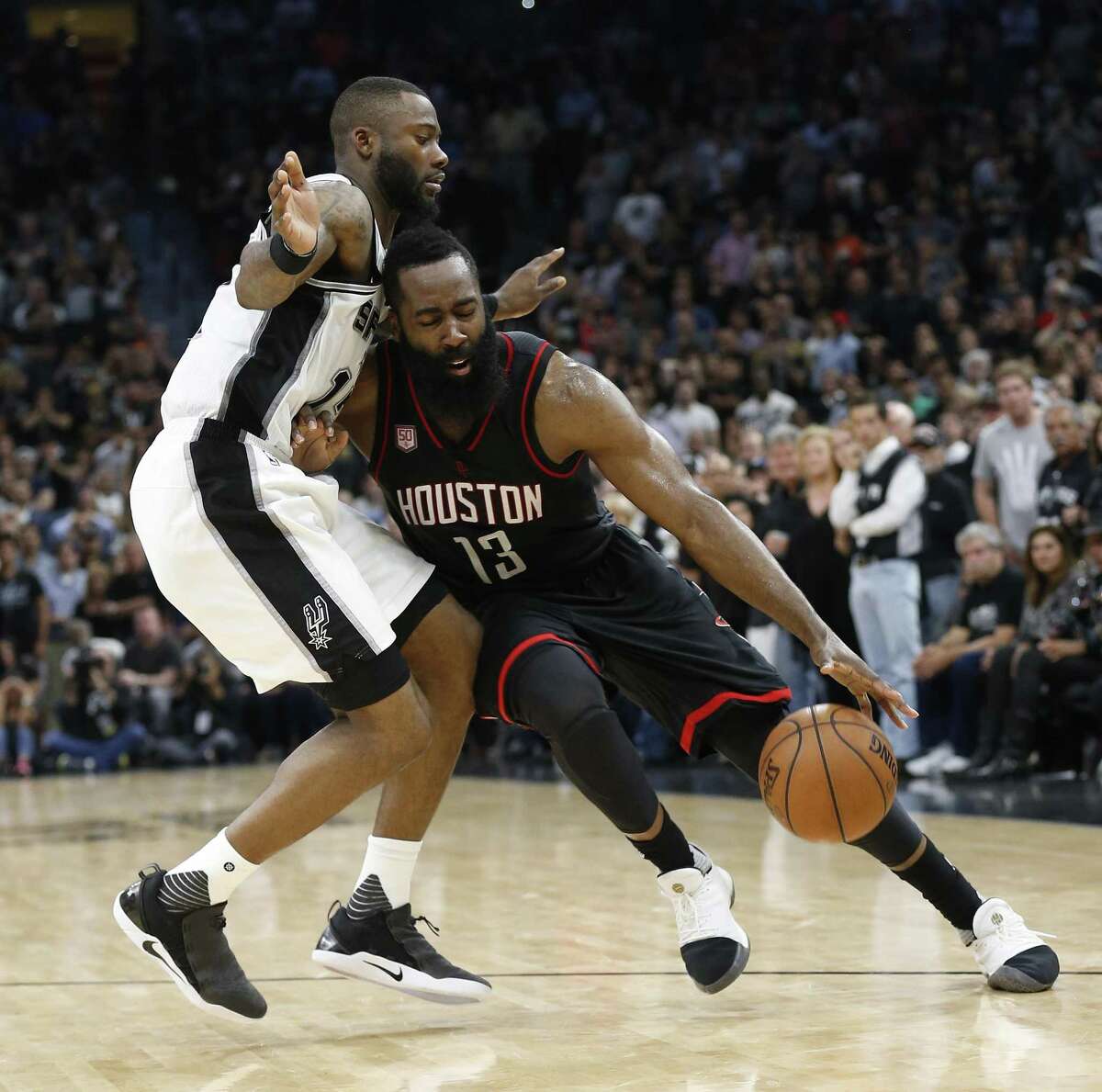 Spurs’ Jonathon Simmons draws a charging fould against the Rockets’ James Harden during Game 5 at the AT&T Center on May 9, 2017.