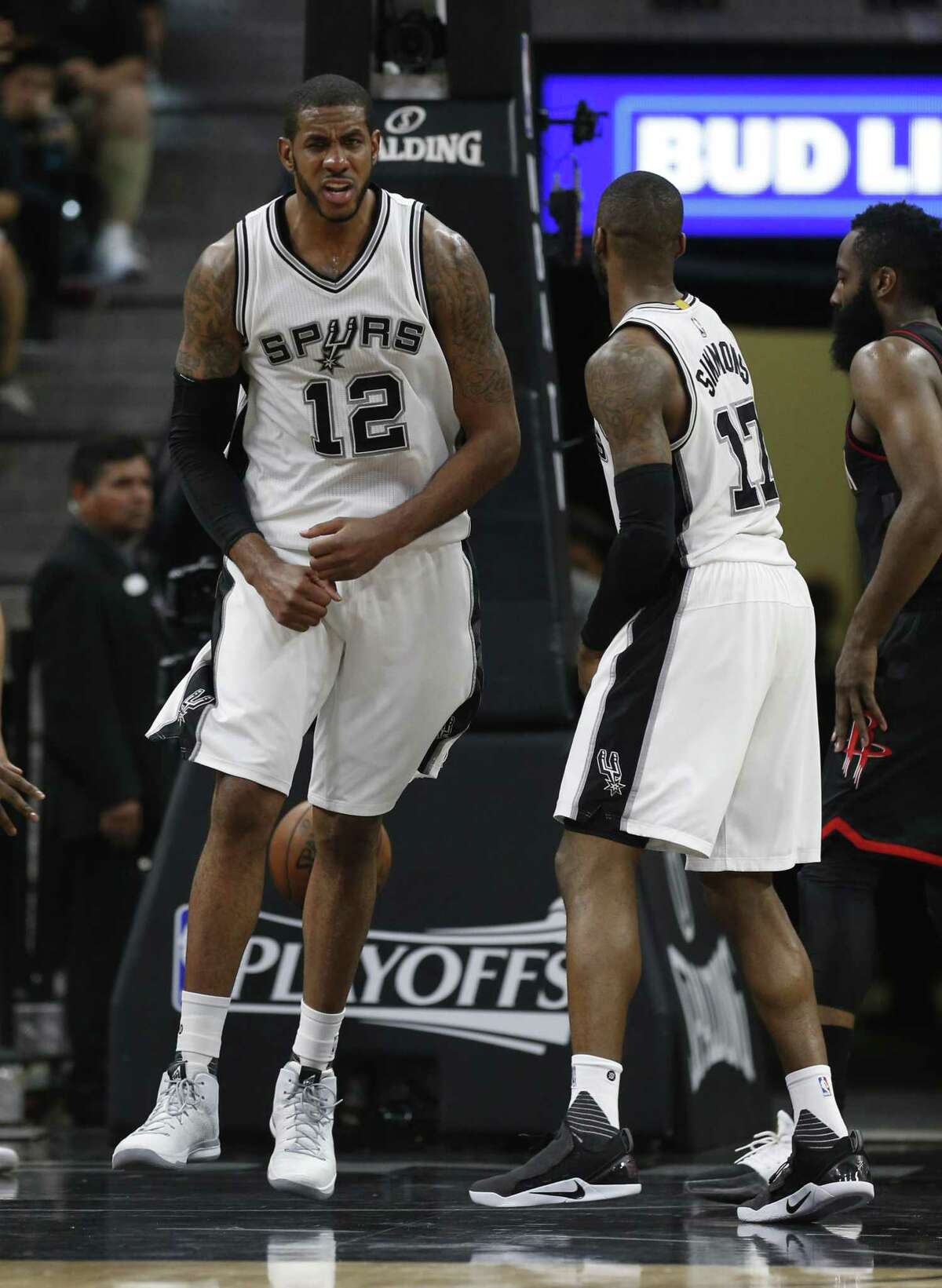Spurs’ LaMarcus Aldridge (12) reacts after making a bucket with Jonathon Simmons against the Rockets in Game 5 at the AT&T Center on May 9, 2017.
