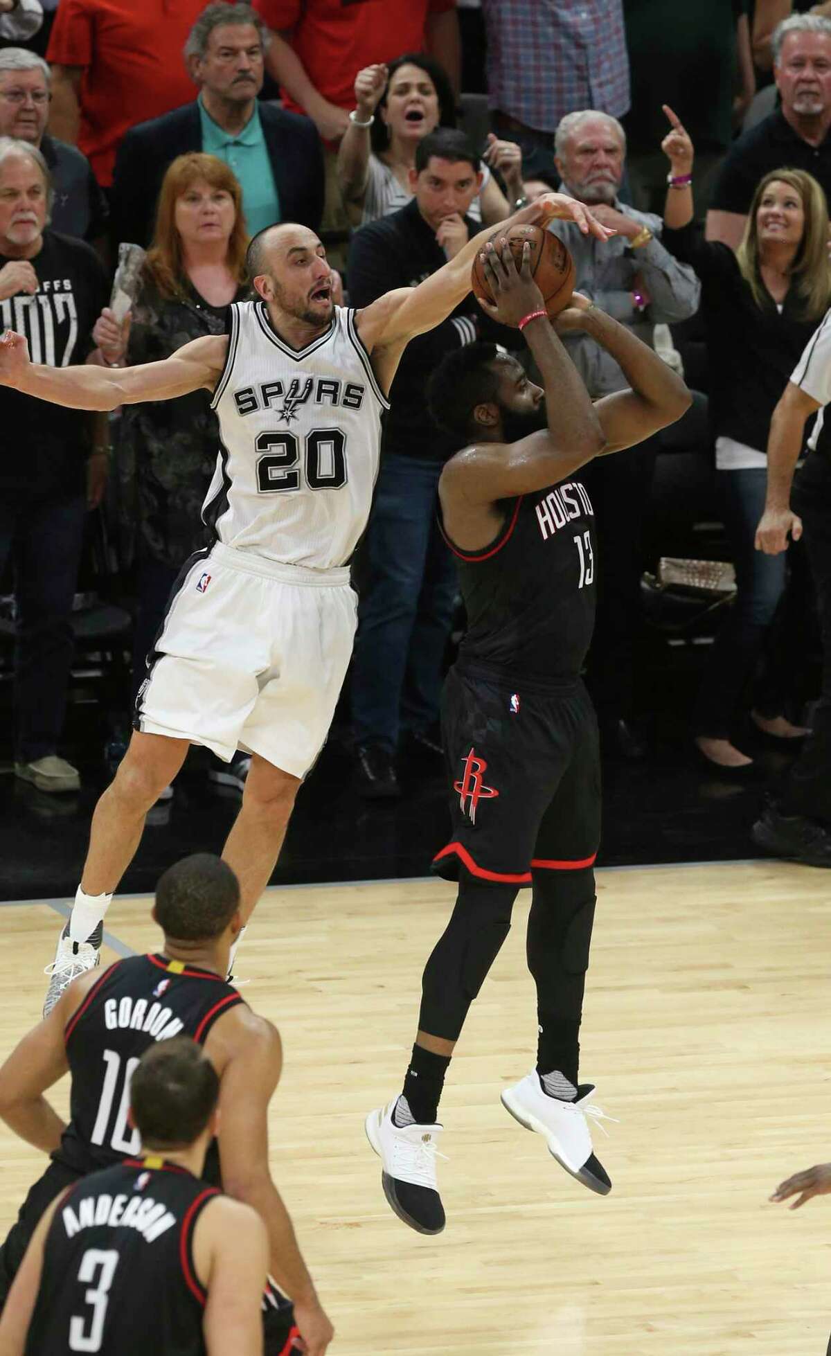 Spurs’ Manu Ginobili blocks Houston Rockets’ James Harden at the end of overtime in the Western Conference semifinals at the AT&T Center on May 9, 2017. The Spurs won in overtime 110-107 to go up in the series, 3-2.